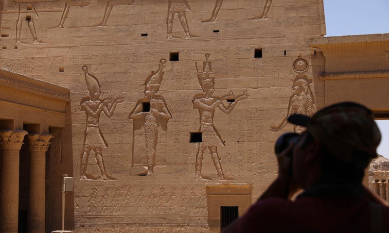 A tourist takes photos at the Philae temples on Agilkia Island in Aswan, Egypt, on June 26, 2021.Photo:Xinhua