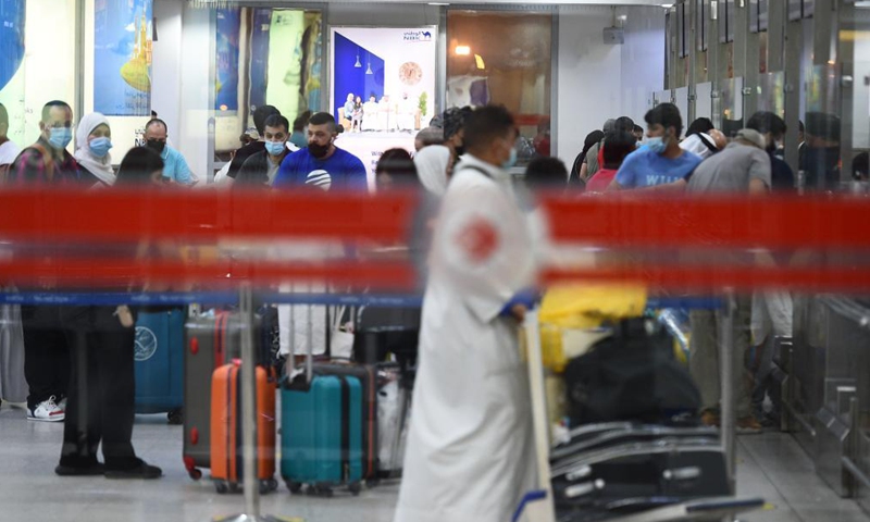 Passengers check in at the departure hall of Kuwait International Airport in Farwaniya Governorate, Kuwait, July 7, 2021. Kuwait's airport has increased its capacity to 5,000 arriving passengers per day starting from Wednesday, while the departure capacity is open to all passengers without any restrictions.Photo:Xinhua