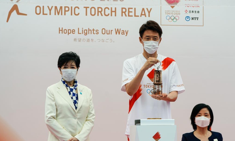 Governor of Tokyo Koike Yuriko (L), Official Ambassador of the Tokyo 2020 Torch Relay Taguchi Aki (R), and Japanese former professional tennis player Matsuoka Shuzo attend the unveiling ceremony for the Olympic Flame of the Olympic Torch Relay in Tokyo, Japan on July 9, 2021.Photo:Xinhua