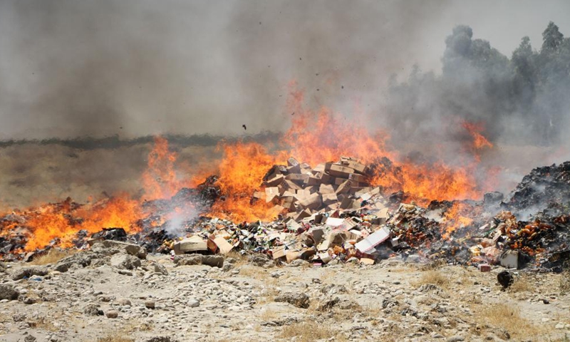 Photo taken on July 8, 2021 shows burning expired medicines and substandard food items in Jalalabad, capital of Nangarhar province, Afghanistan. The Afghan health authorities set on fire up to 170 tons of expired medicines and substandard food items in the country's eastern Nangarhar province on Thursday, the provincial government confirmed. Photo:Xinhua