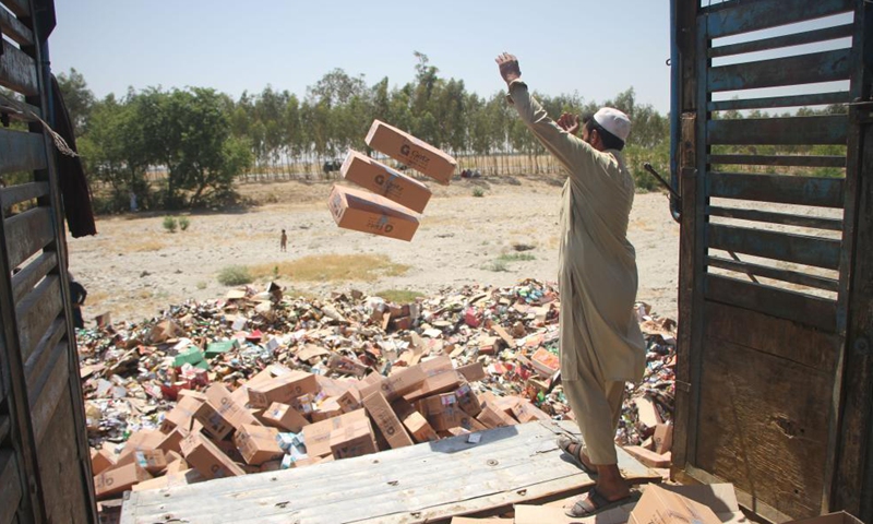 A man unloads expired medicines and substandard food items in Jalalabad, capital of Nangarhar province, Afghanistan, on July 8, 2021. Photo:Xinhua