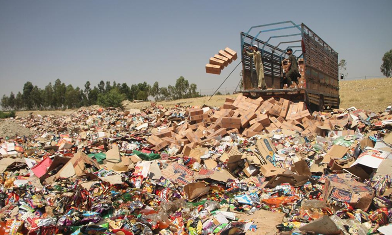 People unload expired medicines and substandard food items in Jalalabad, capital of Nangarhar province, Afghanistan, on July 8, 2021.Photo:Xinhua