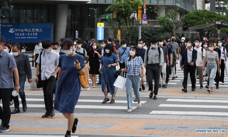 People wearing face masks walk across the street near Yongsan Station in Seoul, South Korea, July 8, 2021. South Korea reported its highest-ever daily COVID-19 cases Thursday, leading the health authorities to officially announce that the country entered the fourth wave of the pandemic.Photo:Xinhua