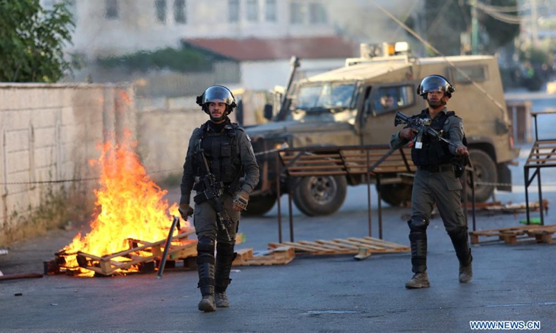 Members of Israeli border police hold their weapons during clashes after Israeli forces blew up the house of Palestinian-American Muntasser Shalaby, in the village of Turmus Ayya near the West Bank city of Ramallah, July 8, 2021. The Israeli army said on Thursday that its forces demolished the family home of a Palestinian-American accused of carrying out a deadly gun attack in the Israel-occupied West Bank in May.Photo:Xinhua