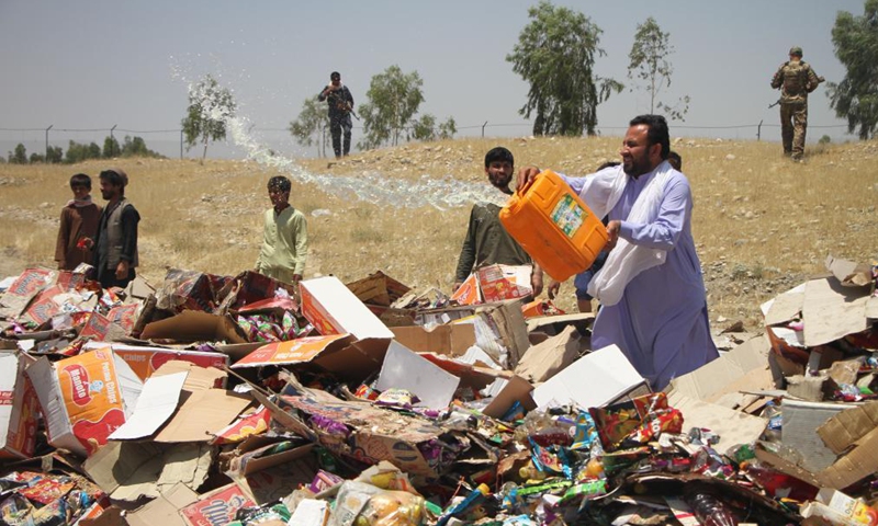 A man prepares to burn expired medicines and substandard food items in Jalalabad, capital of Nangarhar province, Afghanistan, on July 8, 2021. The Afghan health authorities set on fire up to 170 tons of expired medicines and substandard food items in the country's eastern Nangarhar province on Thursday, the provincial government confirmed.Photo:Xinhua