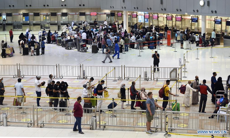 Passengers wait to check in at the departure hall of Kuwait International Airport in Farwaniya Governorate, Kuwait, July 7, 2021. Kuwait's airport has increased its capacity to 5,000 arriving passengers per day starting from Wednesday, while the departure capacity is open to all passengers without any restrictions. Photo:Xinhua