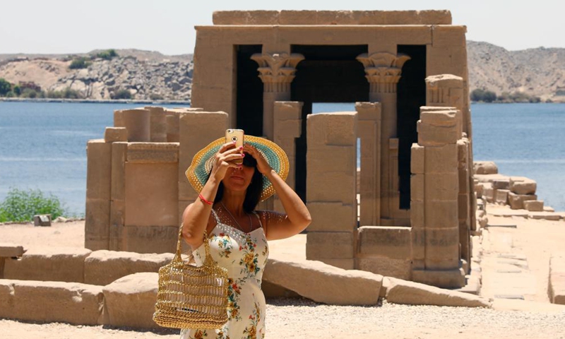 A tourist takes photos at the Philae temples on Agilkia Island in Aswan, Egypt, on June 26, 2021.Photo:Xinhua
