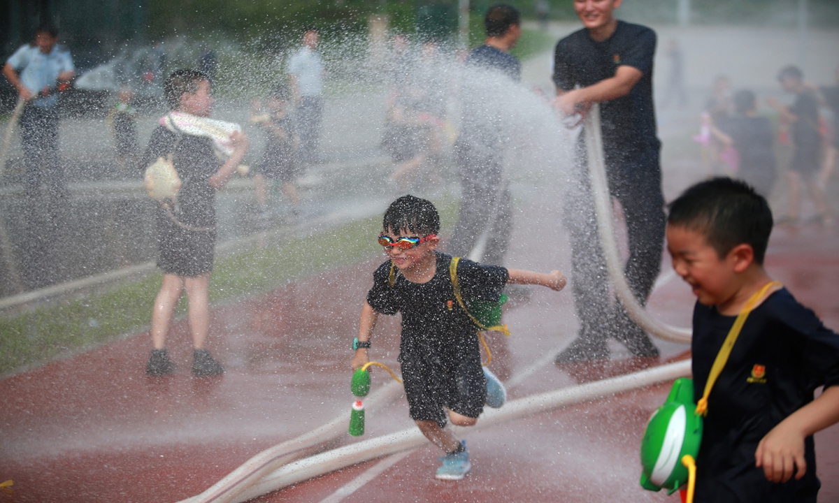 Kids have a water fight on Sunday in East China's Jiangsu Province. Photo: VCG