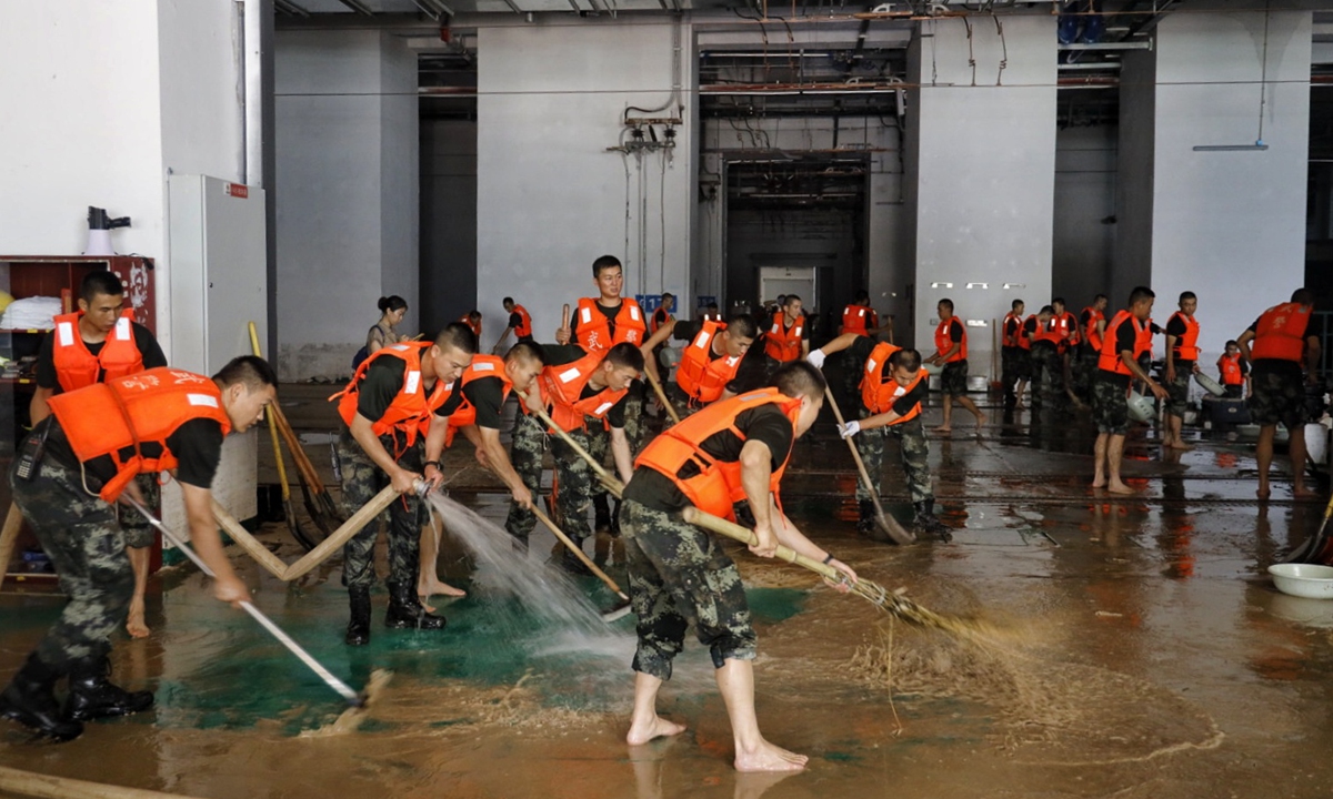 People's Liberation Armed Police help clean a hangar for subway trains in Zhengzhou, Central China's Henan Province on Friday, after the city was flooded due to record downpours. Photo: Li Hao/GT