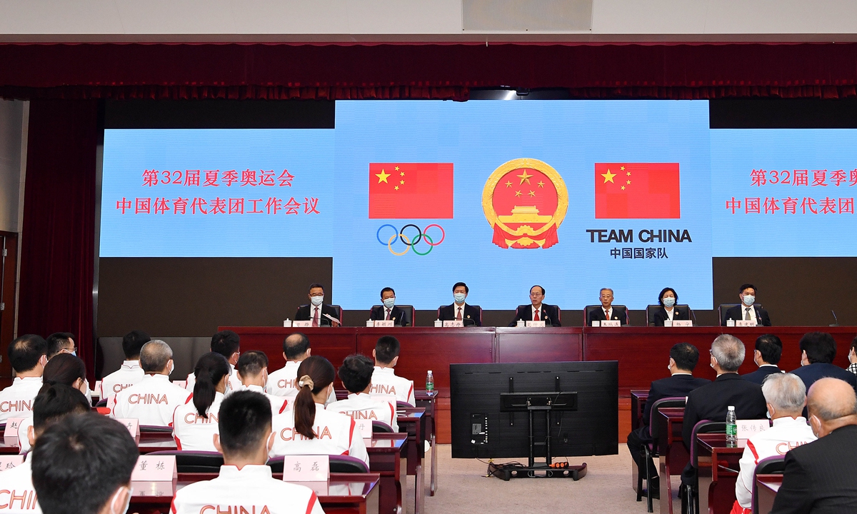 Representatives of the Chinese delegation for the Tokyo Olympics attend a meeting in Beijing on Wednesday. The delegation,  including 298 female athletes and 133 male athletes, will compete in 225 events at the Games, which are scheduled to open on July 23. Photo: Xinhua