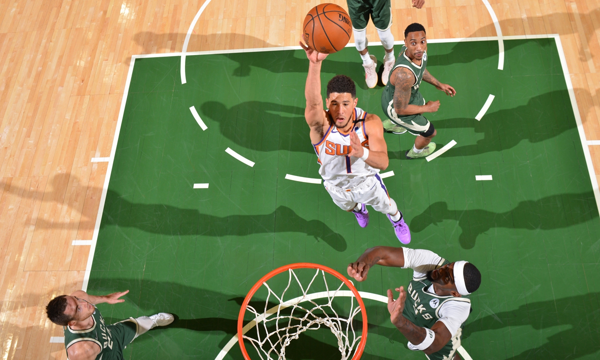 Devin Booker of the Phoenix Suns shoots the ball against the Milwaukee Bucks during Game Three of the NBA Finals on July 11 in Milwaukee, Wisconsin. Photo: VCG