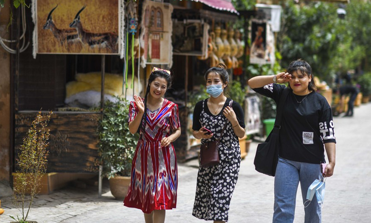 Local residents walk in a street at a scenic spot in the ancient city of Kashgar, northwest China's Xinjiang Uygur Autonomous Region, May 16, 2020. (Xinhua/Zhao Ge)
