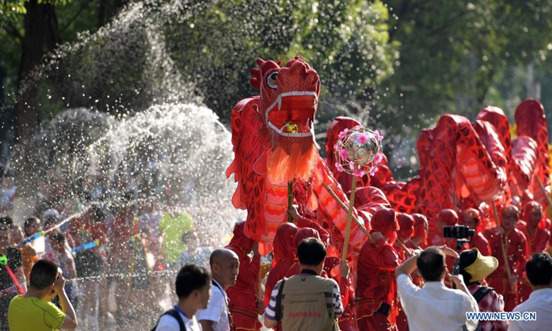 A dragon dance team performs amid splashes of water to celebrate Liuyueliu, an ethnic festival, in Jianhe County of Qiandongnan Miao and Dong Autonomous Prefecture, southwest China's Guizhou Province, July 15, 2021. (Photo:Xinhua)