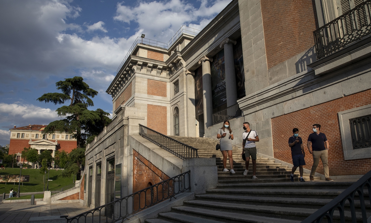 People wearing face masks walk out from the Prado Museum on June 7 in Madrid. Photo: VCG