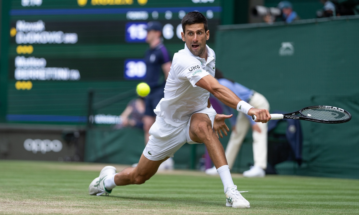 Novak Djokovic of Serbia plays a backhand against Matteo Berrettini of Italy in the final of the men’s singles final during the Wimbledon Championships on July 11. Photo: VCG