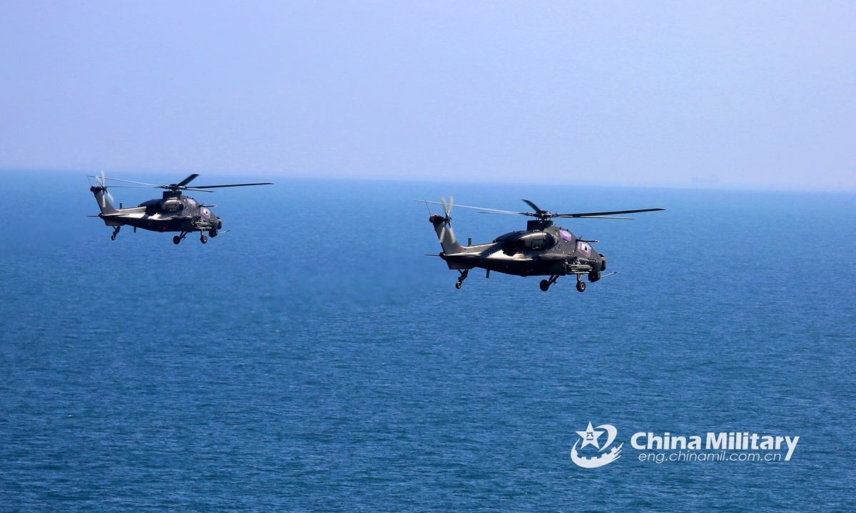 Two attack helicopters attached to an army aviation brigade under the PLA Eastern Theater Command fly in alongside formation above the sea at an ultra-low altitude during a flight training exercise on June 9, 2021. The flight training covered the subjects of two-plane formation flight, island defense penetration at low-altitude, maritime assault, etc.Photo:China Military