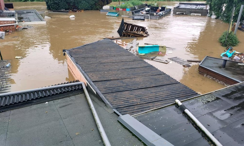 Photo taken with a mobile phone on July 15, 2021 shows flooded houses in Liege, Belgium. Torrential rain has caused severe disruptions in Belgium on Thursday, with entire streets and villages inundated by heavy flooding.Photo:Xinhua