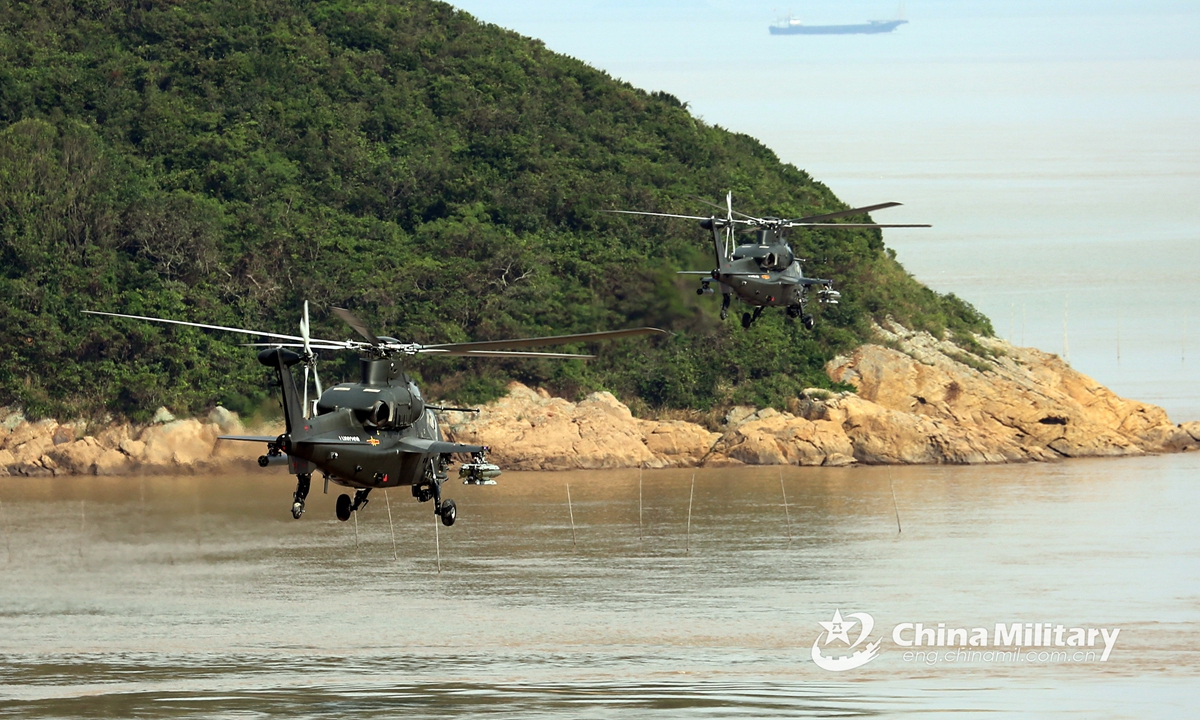 Two attack helicopters attached to an army aviation brigade under the PLA Eastern Theater Command fly in alongside formation above the sea at an ultra-low altitude during a flight training exercise on June 9, 2021. The flight training covered the subjects of two-plane formation flight, island defense penetration at low-altitude, maritime assault, etc.Photo:China Military