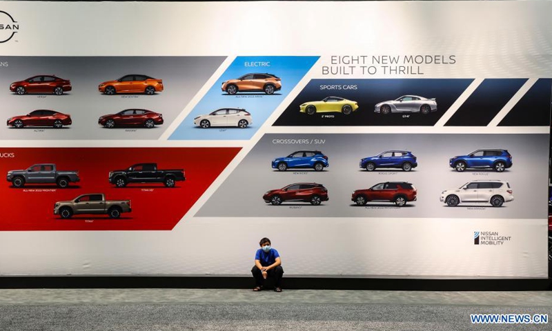 A visitor sits in front of a Nissan display at the 2021 Chicago Auto Show held at McCormick Place in Chicago, the United States, on July 15, 2021. The 2021 Chicago Auto Show kicked off on Thursday with more than 20 manufacturers from all over the world showcasing their latest vehicles.Photo:Xinhua