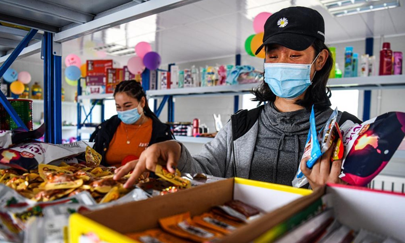 Local residents buy food in a marketplace designed to provide job opportunities to low-income families at Karatokay Township, Tekes County, northwest China's Xinjiang Uygur Autonomous Region, June 29, 2020.Photo:Xinhua