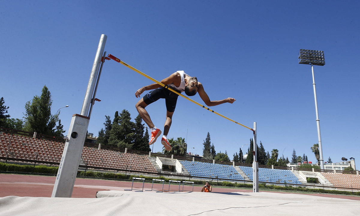 Syrian high jump player Majd Eddin Ghazal trains for the Tokyo Olympics in Damascus on June 30. Photo: AFP
