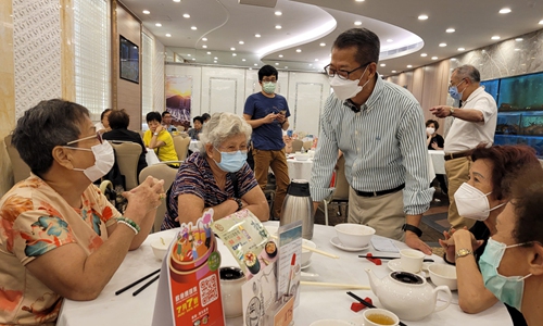 Chan Mo-po talking with customers in restaurant 