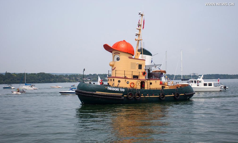People welcome the tugboat Theodore Too upon its arrival at the Port of Hamilton in Hamilton, Ontario, Canada, on July 18, 2021. Theodore Too, a 65-foot replica of beloved children's TV character, Theodore Tugboat, arrived in Hamilton on Sunday after a journey from Halifax on a mission to promote water conservation.(Photo: Xinhua)