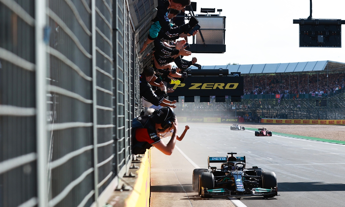 Mercedes' Lewis Hamilton behind the wheel celebrating during the F1 Grand Prix of Great Britain at the Silverstone circuit on July 18. Photo: VCG