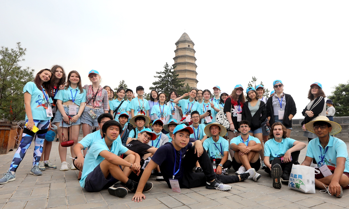 Foreign students have a group photo taken in front of the Baota Mountain. Photo: Chen Xia/GT