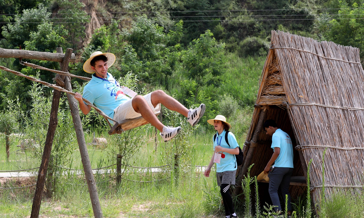 Andrew Trybus, a 16-year-old American student, plays on a swing. Photo: Chen Xia/GT