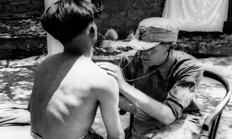 Frey treats an injured Eighth Route Army soldier on the frontline against Japanese aggression
