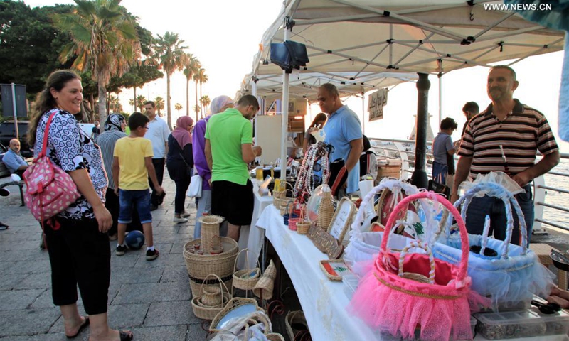 People visit a popular fair of handicrafts and local products at Beirut Corniche in Beirut, Lebanon, on July 18, 2021. (Photo: Xinhua)