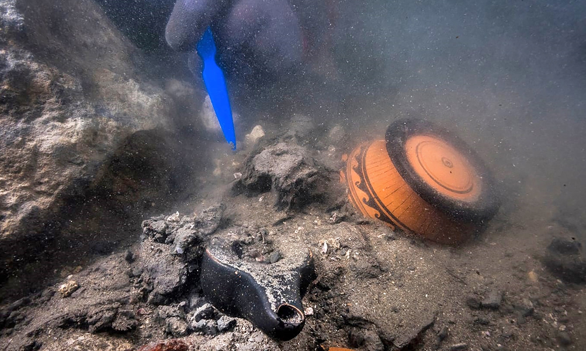 A diver unearths pieces of pottery in the sunken city of Thonis-Heracleion in Abu Qir bay off Egypt's northern Mediterranean coast on Monday.  
Below: A golden fragment uncovered in the sunken city of Thonis-Heracleion Photos: AFP