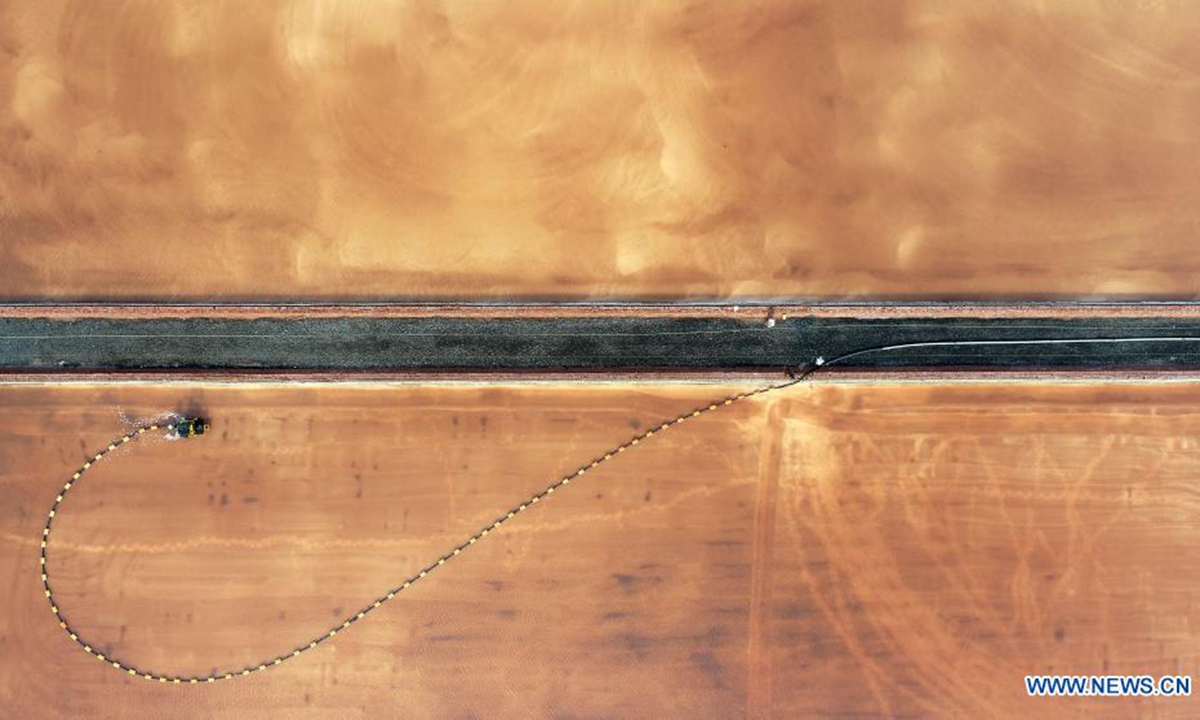 Aerial photo taken on July 19, 2021 shows an employee working at the Changlu Daqinghe saltworks in Tangshan, north China's Hebei Province. (Photo by Li Lei/Xinhua)