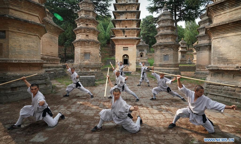 Shaolin monks practice martial arts at Pagoda Forest of Shaolin Temple in Dengfeng City, central China's Henan Province, July 8, 2021. Located on the Songshan Mountain, Shaolin Temple is the birthplace for Shaolin Martial Arts.(Photo: Xinhua)