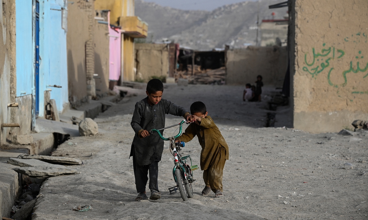 Children play with a cycle at a residential area in Kabul on July 11, 2021. Photo: AFP