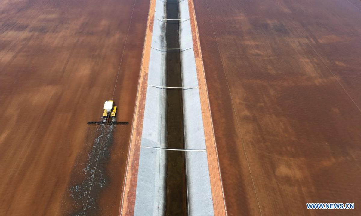 Aerial photo taken on July 19, 2021 shows an employee working at the Changlu Daqinghe saltworks in Tangshan, north China's Hebei Province. (Photo by Li Lei/Xinhua)