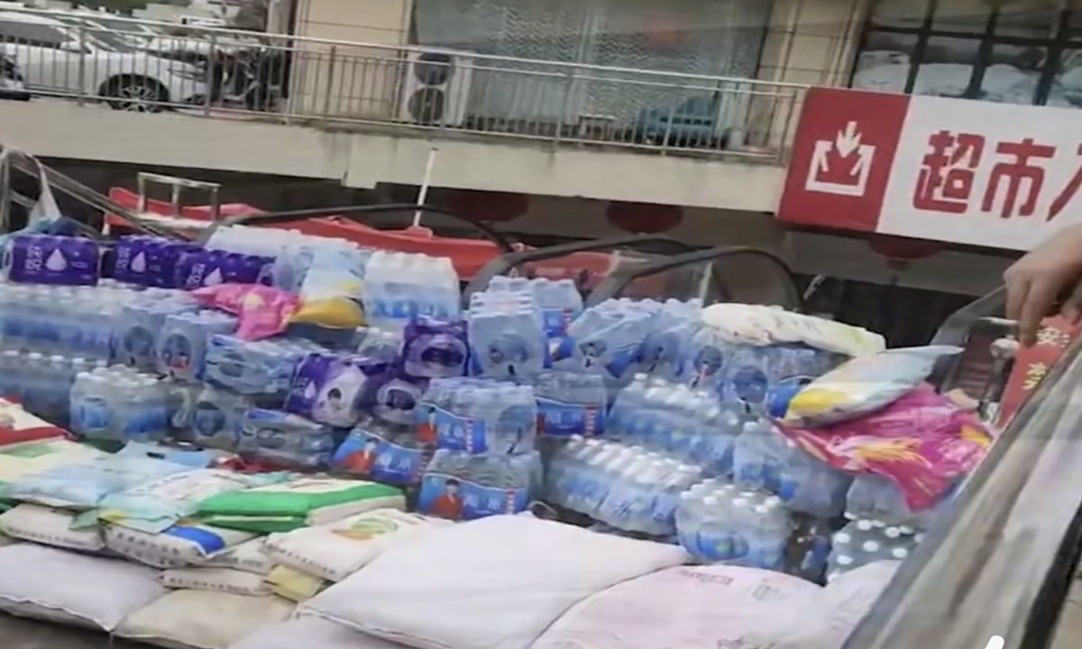 Two supermarkets in Huainan, East China's Anhui Province, used rice and flour bags stored for sale to save themselves from being flooded by heavy rain on Friday. Photo: Sina Weibo
