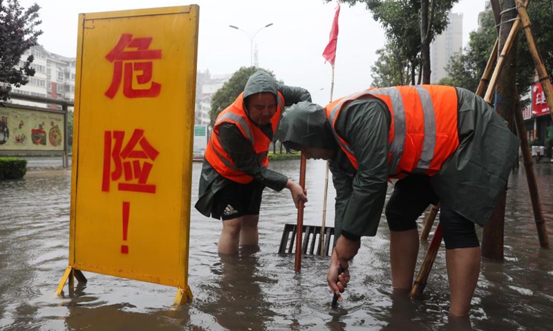 Staff members drain water at a waterlogged area in Wuzhi County, central China's Henan Province, July 20, 2021.(Photo: Xinhua)
