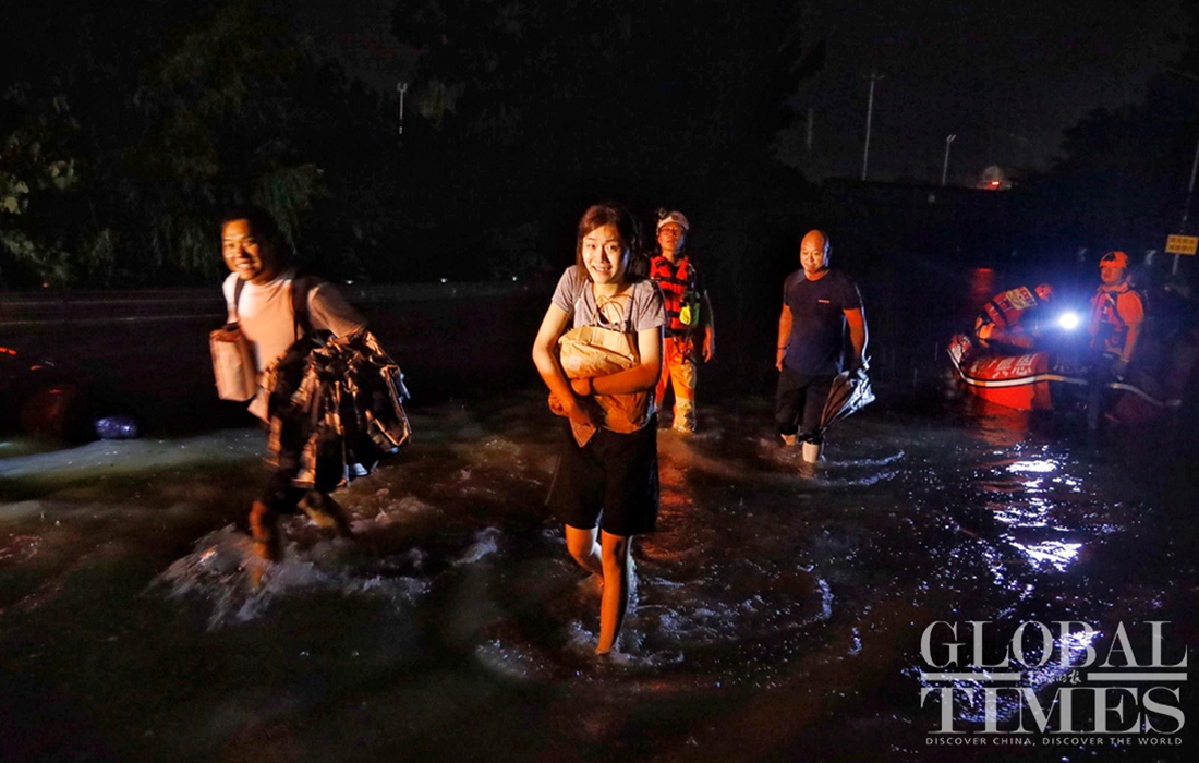 Two stranded residents were transferred out from the deep-watered area. Photo: Li Hao/GT