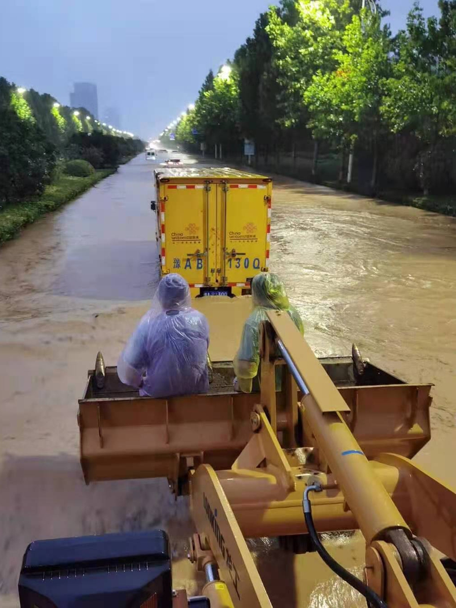 Due to flooding, workers at China Unicom use an excavator to repair a data center in Zhengzhou on Tuesday. Photo: Courtesy of China Unicom Henan branch 