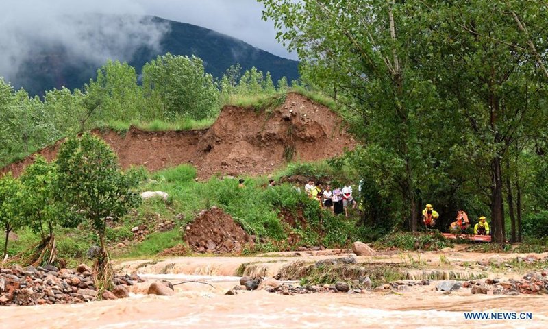 Rescuers transfer stranded villagers in Longtou Village, Dengfeng City of central China's Henan Province, July 20, 2021. Longtou Village was hit by mountain torrents on Tuesday. Rescuers have transferred over 50 villagers to safer places. (Photo: Xinhua)