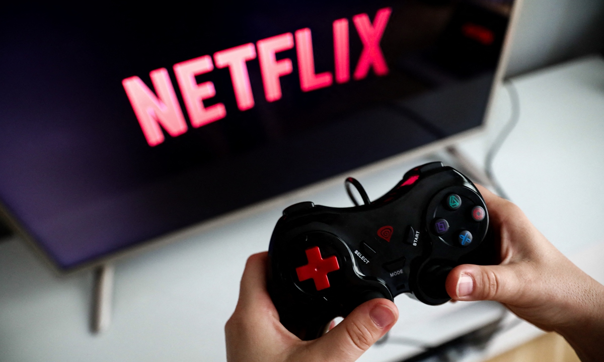 Netflix logo displayed on a TV screen and a gamepad are seen on this illustration photo taken in Krakow, Poland on Monday. Photo: AFP