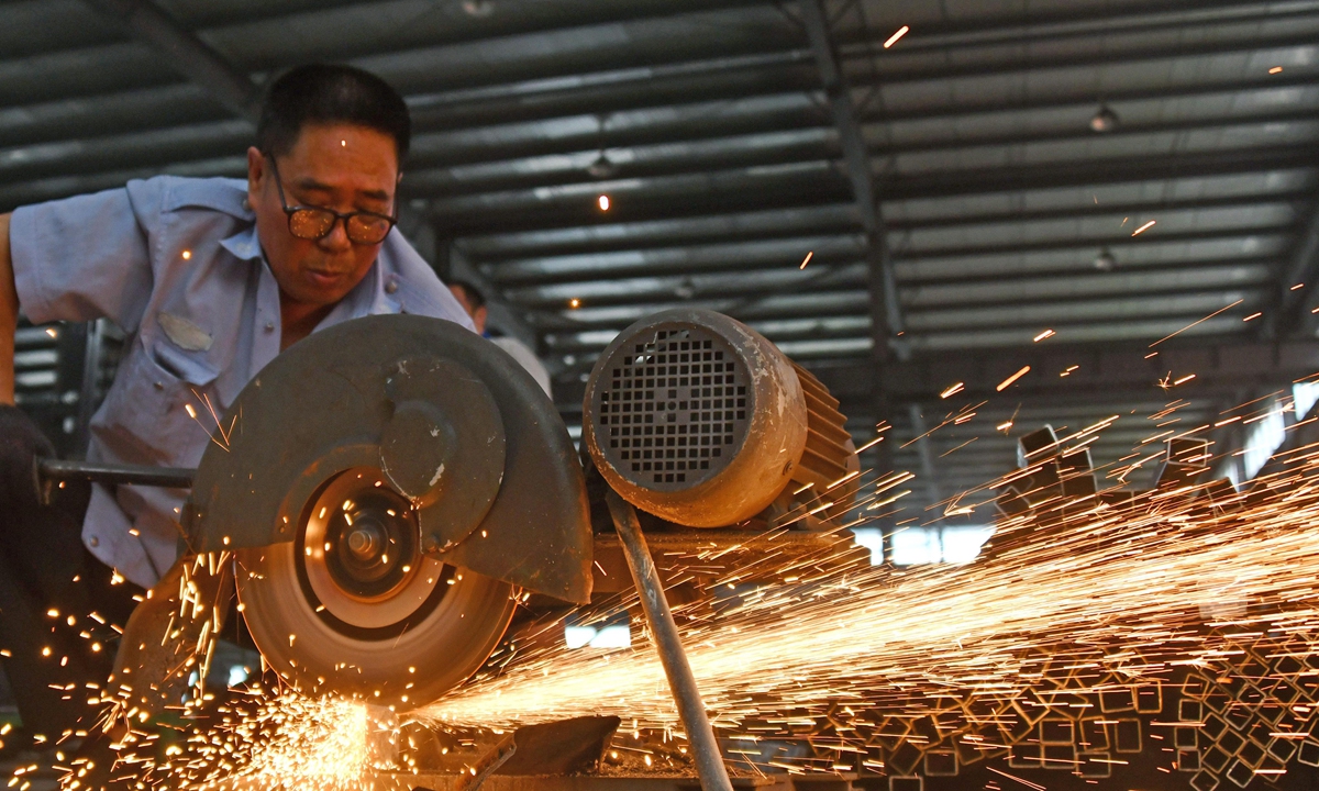 Work goes on in a factory providing components for new-energy vehicles on Thursday. More than 1.1 million new-energy cars were registered in China in the first half of this year, a record high for the period in any year, official data showed. Photo: cnsphoto