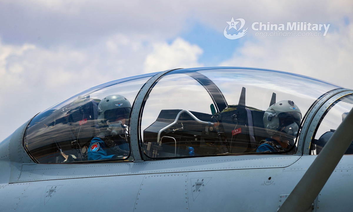 Pilots assigned to an aviation brigade under the PLA Southern Theater Command get well-prepared in their cockpit prior to a live-fire flight training exercise on July 13, 2021.Photo: China Military Online