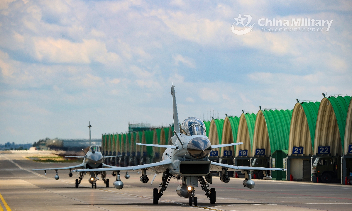 Two fighter jets attached to an aviation brigade under the PLA Southern Theater Command taxi in formation toward the flightline for a live-fire flight training exercise on July 13, 2021. Photo: China Military Online