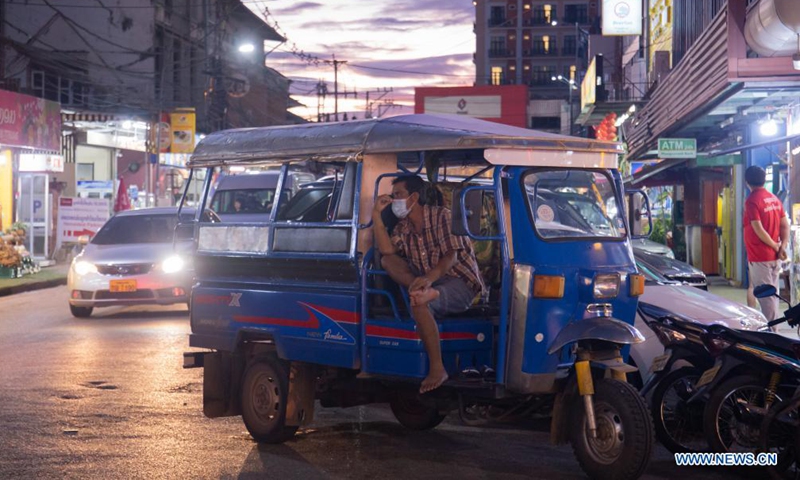 A Tuk-Tuk driver waits for customers near a night market in Vientiane, Laos, on July 21, 2021. Lao government on Monday decided to extend the ongoing lockdown for another 15 days to help curb COVID-19 infections.Photo:Xinhua