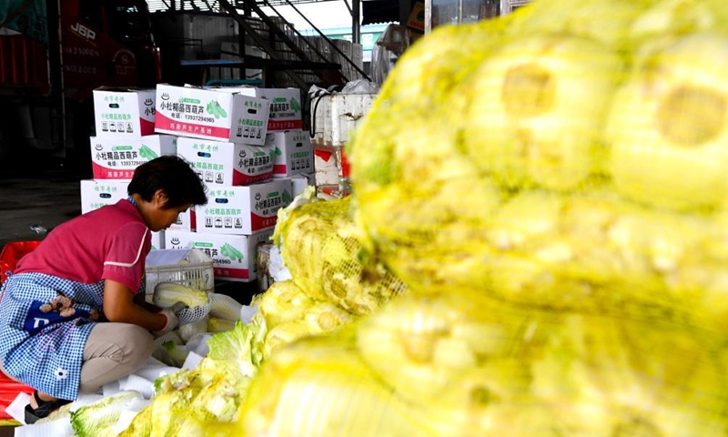 A staff member arranges vegetables at a logistic center in Zhongmu County of Zhengzhou, central China's Henan Province, July 22, 2021.Photo:Xinhua