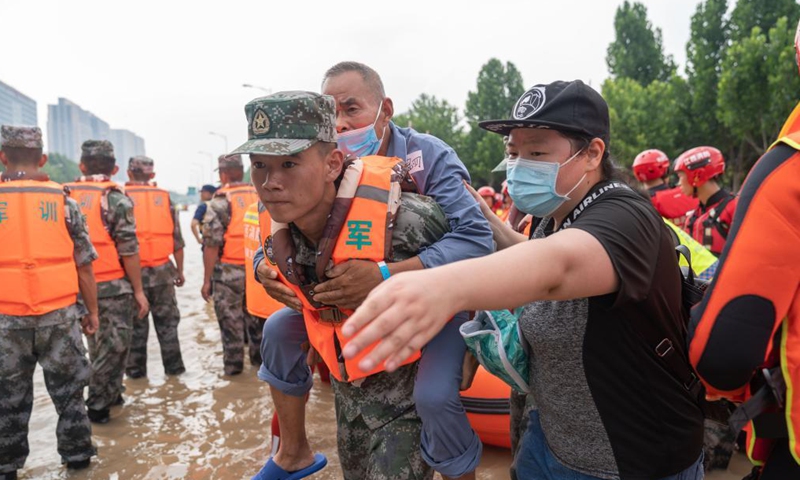 Rescuers help a petient to evacuate near the Fuwai Central China Cardiovascular Hospital in Zhongmu County of Zhengzhou, central China's Henan Province, July 22, 2021.Photo:Xinhua