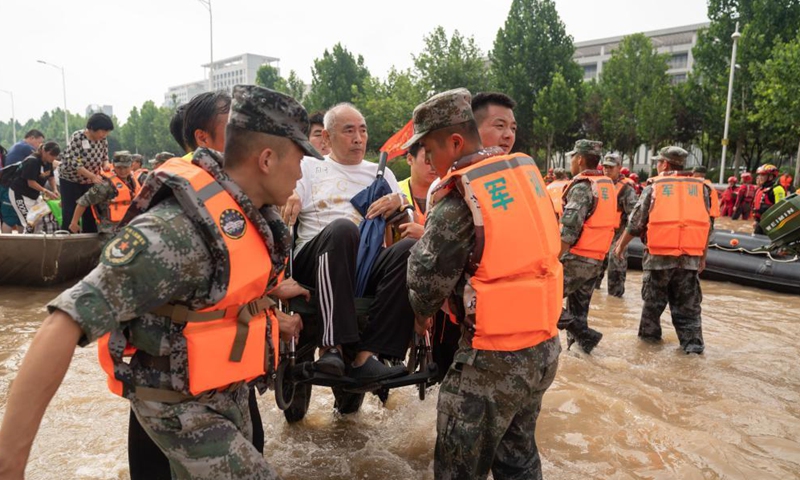 Rescuers help to evacuate a patient near the Fuwai Central China Cardiovascular Hospital in Zhongmu County of Zhengzhou, central China's Henan Province, July 22, 2021.Photo:Xinhua
